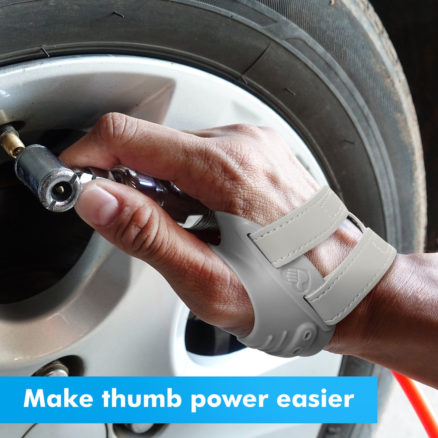 Person wearing a gray Fortemotus thumb brace inflating a car tire, demonstrating support for thumb strength during automotive tasks