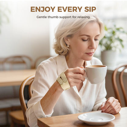 A woman sitting at a cafe table holding a white coffee cup, wearing a beige wrist cuff with a gold-toned metal thumb support. Text at the top reads 'ENJOY EVERY SIP' and 'Gentle thumb support for relaxing.